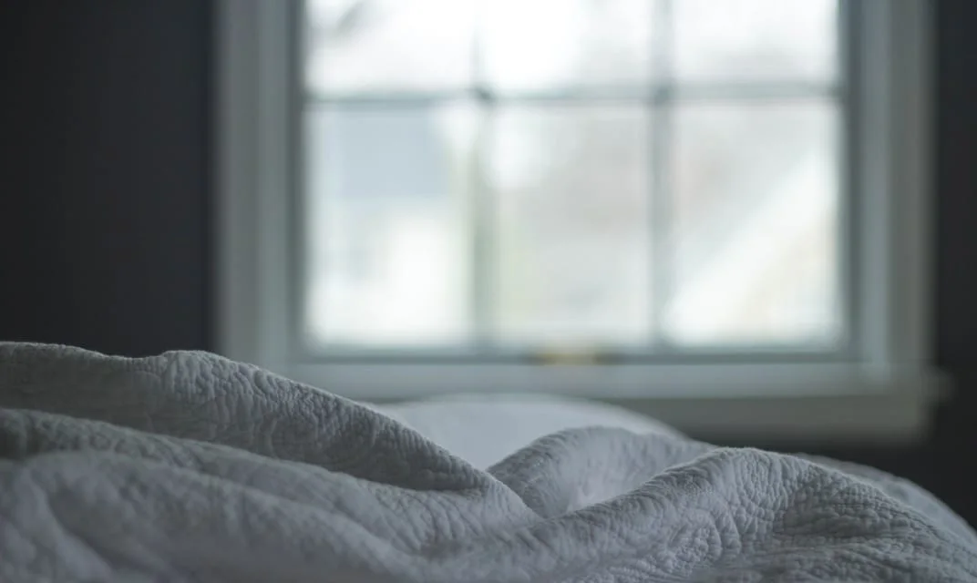 Early morning light coming through a bedroom window.