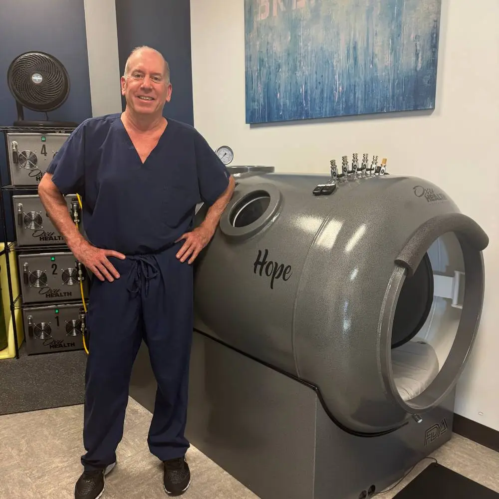 Doctor standing in front of hyperbaric chamber